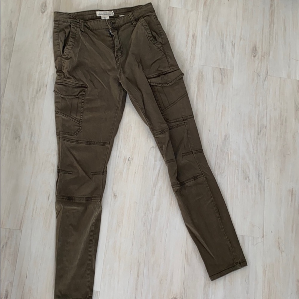 Olive green pants with a lot of pockets.